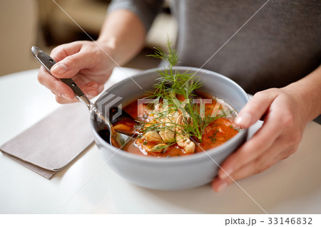 woman eating seafood soup at restaurant 33146832