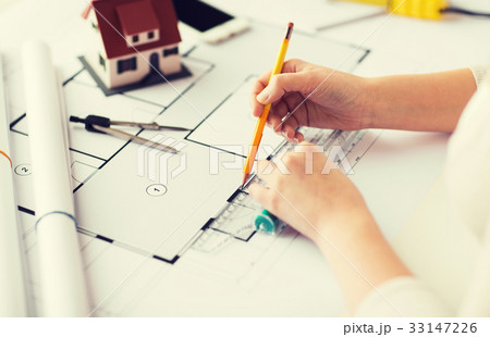 close up of hands with compass measuring blueprint close up of hands with compass measuring blueprint 33147226