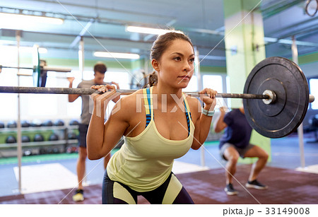 group of people training with barbells in gym 33149008