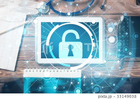 Top view of doctor workplace with tablet pc and medicine tools on wooden table Top view of doctor workplace with tablet pc and medicine tools on wooden table 33149038