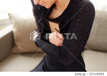 woman with photo frame at funeral day woman with photo frame at funeral day 33149092