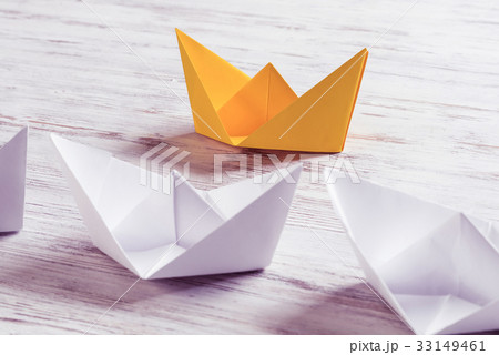 Business leadership concept with white and color paper boats on Business leadership concept with white and color paper boats on 33149461