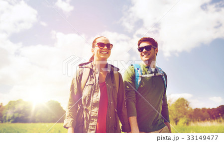 happy couple with backpacks hiking outdoors 33149477