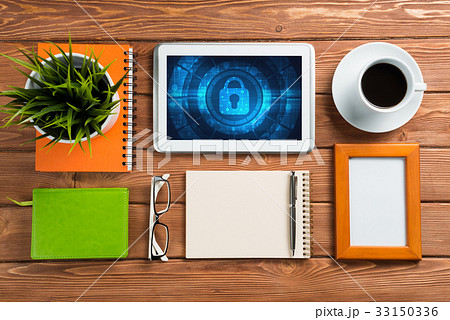 Web security and technology concept with tablet pc on wooden table Web security and technology concept with tablet pc on wooden table 33150336