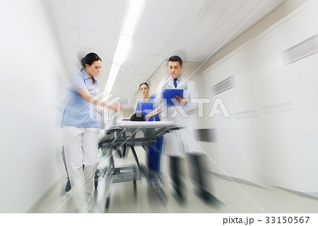 medics and patient on hospital gurney at emergency 33150567