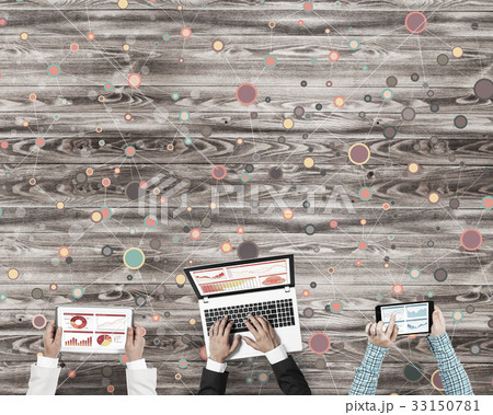 Top view of businesspeople sitting at table and using gadgets 33150781