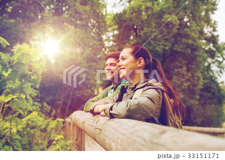 smiling couple with backpacks in nature 33151171