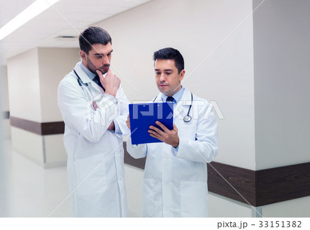 two male doctors with clipboard at hospital 33151382