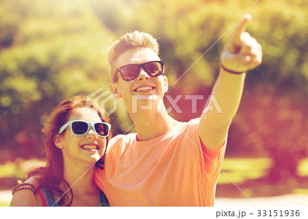happy couple pointing finger at summer park 33151936