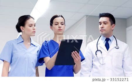 group of medics at hospital with clipboard group of medics at hospital with clipboard 33152271
