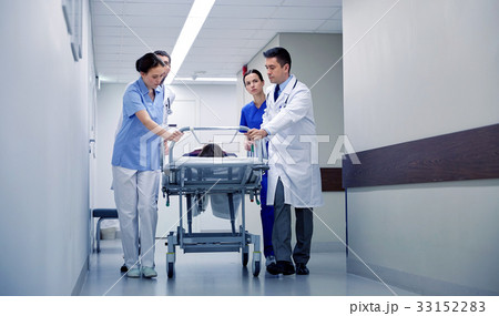 medics and patient on hospital gurney at emergency 33152283