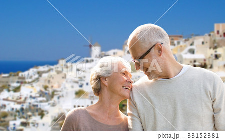 happy senior couple over santorini island happy senior couple over santorini island 33152381