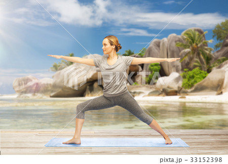 woman doing yoga warrior pose on beach woman doing yoga warrior pose on beach 33152398
