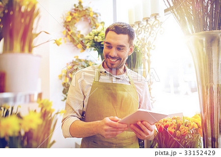 man with tablet pc computer at flower shop 33152429