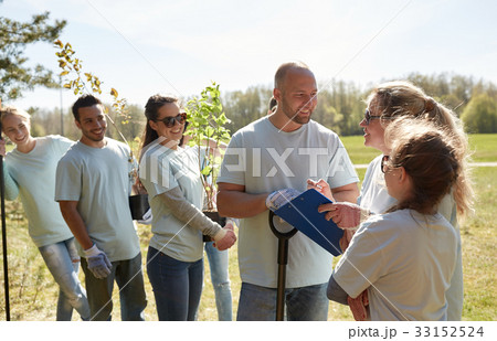 group of volunteers with tree seedlings in park group of volunteers with tree seedlings in park 33152524
