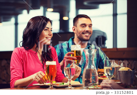 friends dining and drinking beer at restaurant friends dining and drinking beer at restaurant 33152801