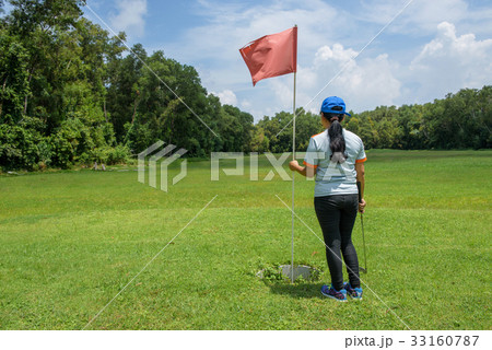 Asian black long hair standing beside golf pole Asian black long hair standing beside golf pole 33160787