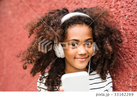Beautiful african american girl with smart phone Beautiful african american girl with smart phone 33162269