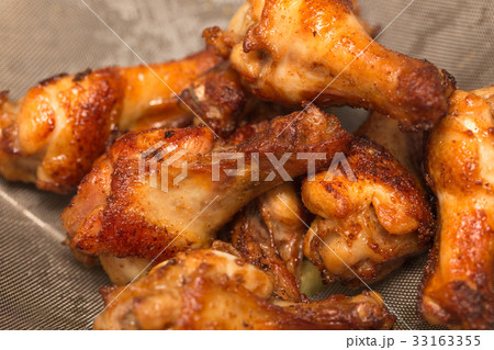 fried chicken on oil strainer background fried chicken on oil strainer background 33163355