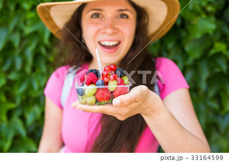 Young happy girl with fresh berries 33164599