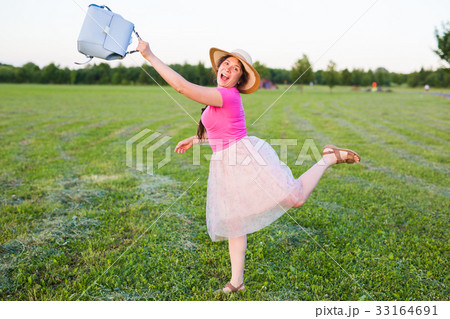 beautiful young woman laughs and dances outdoors 33164691