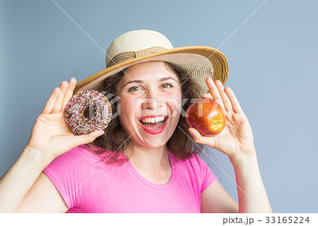 Beauty girl taking colorful donuts. Funny joyful Beauty girl taking colorful donuts. Funny joyful 33165224