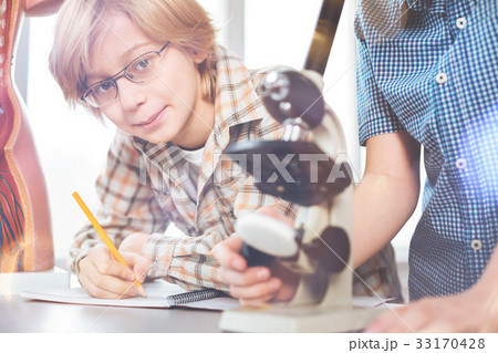 Portrait of handsome boy while making notes 33170428