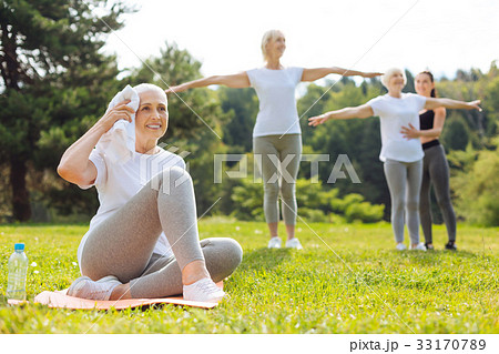 Smiling woman wiping her head with towel 33170789