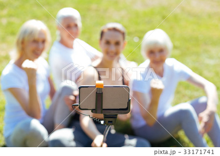 Close up of telephone that being on selfie-stick Close up of telephone that being on selfie-stick 33171741