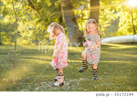 The cute little blond girls in rubber boots 33172194