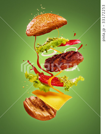 The hamburger with flying ingredients on green 33172253