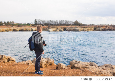 Young photographer on the beach. Traveler 33173937