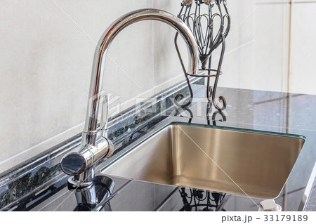 Angle view of kitchen sink with silver faucet Angle view of kitchen sink with silver faucet 33179189