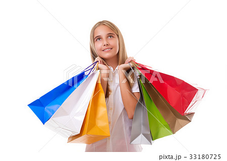 young girl with shopping bags looking up,isolated 33180725