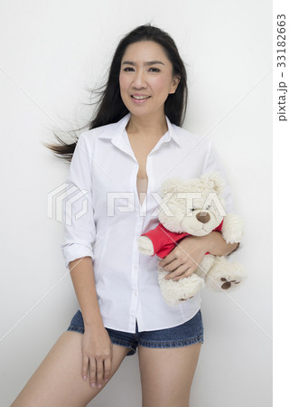 Happy Asian woman holding teddy bear 33182663