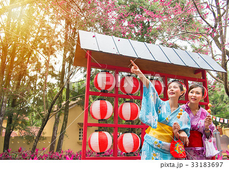 female travelers wearing kimono pointing sakura female travelers wearing kimono pointing sakura 33183697
