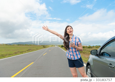 pretty woman with hand up calling passing car pretty woman with hand up calling passing car 33183757