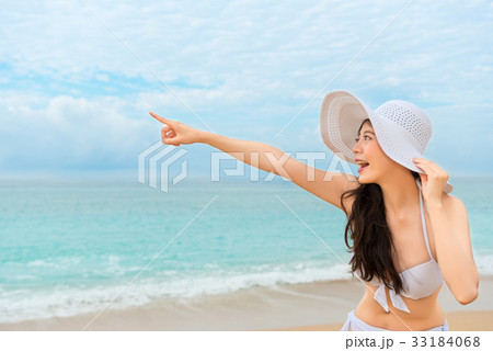 bikini model hand pointing gesture with ocean bikini model hand pointing gesture with ocean 33184068