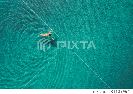 Aerial view of swimming woman in mediterranean sea Aerial view of swimming woman in mediterranean sea 33185964