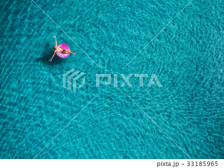 Aerial view of young woman swimming on the sea Aerial view of young woman swimming on the sea 33185965