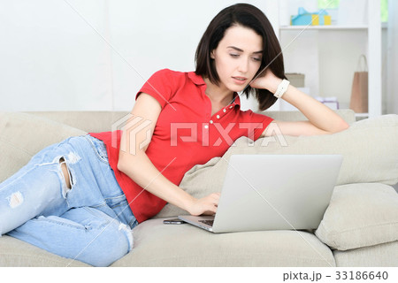 young woman laying on couch 33186640