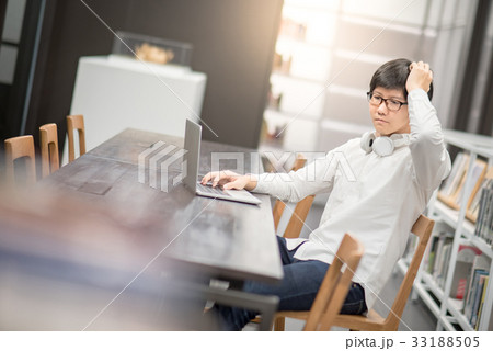 Young Asian university student working in library Young Asian university student working in library 33188505