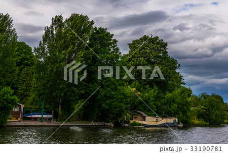 Wide river and houses on the shore, moored boats Wide river and houses on the shore, moored boats 33190781