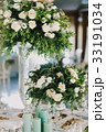 Rich bouquet of roses stands on the dinner table 33191034