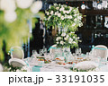 Rich bouquet of roses stands on the dinner table 33191035