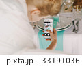 Woman takes a picture of table decor  33191036