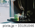 Morning sun shines over the table with alcohol  33191046