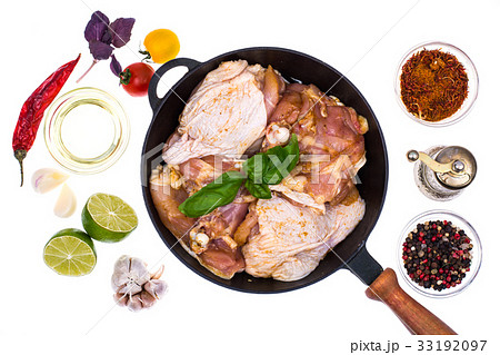 Cast-iron frying pan with marinated chicken thighs 33192097