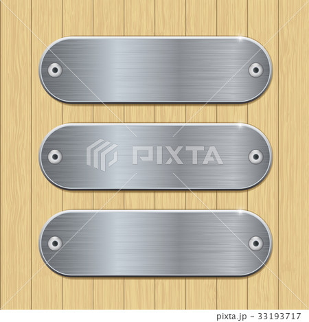 Metal plates on wooden background 33193717