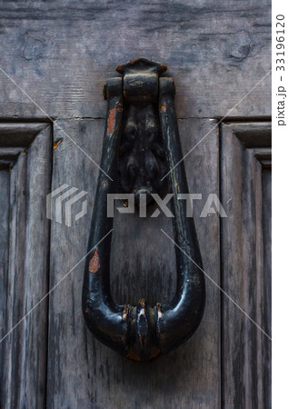 Door with brass knocker in the shape of a hand Door with brass knocker in the shape of a hand 33196120